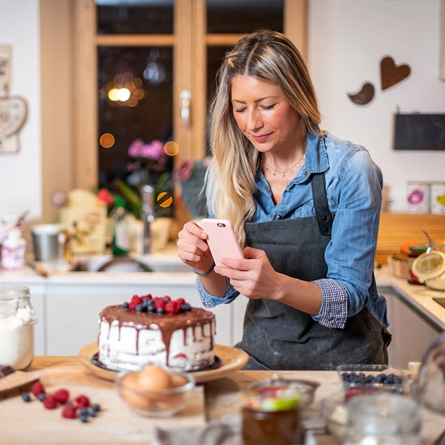 Mujer tomando una foto a una torta