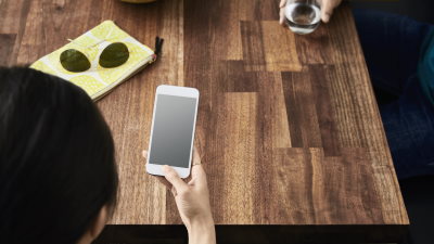 Woman at table using mobile